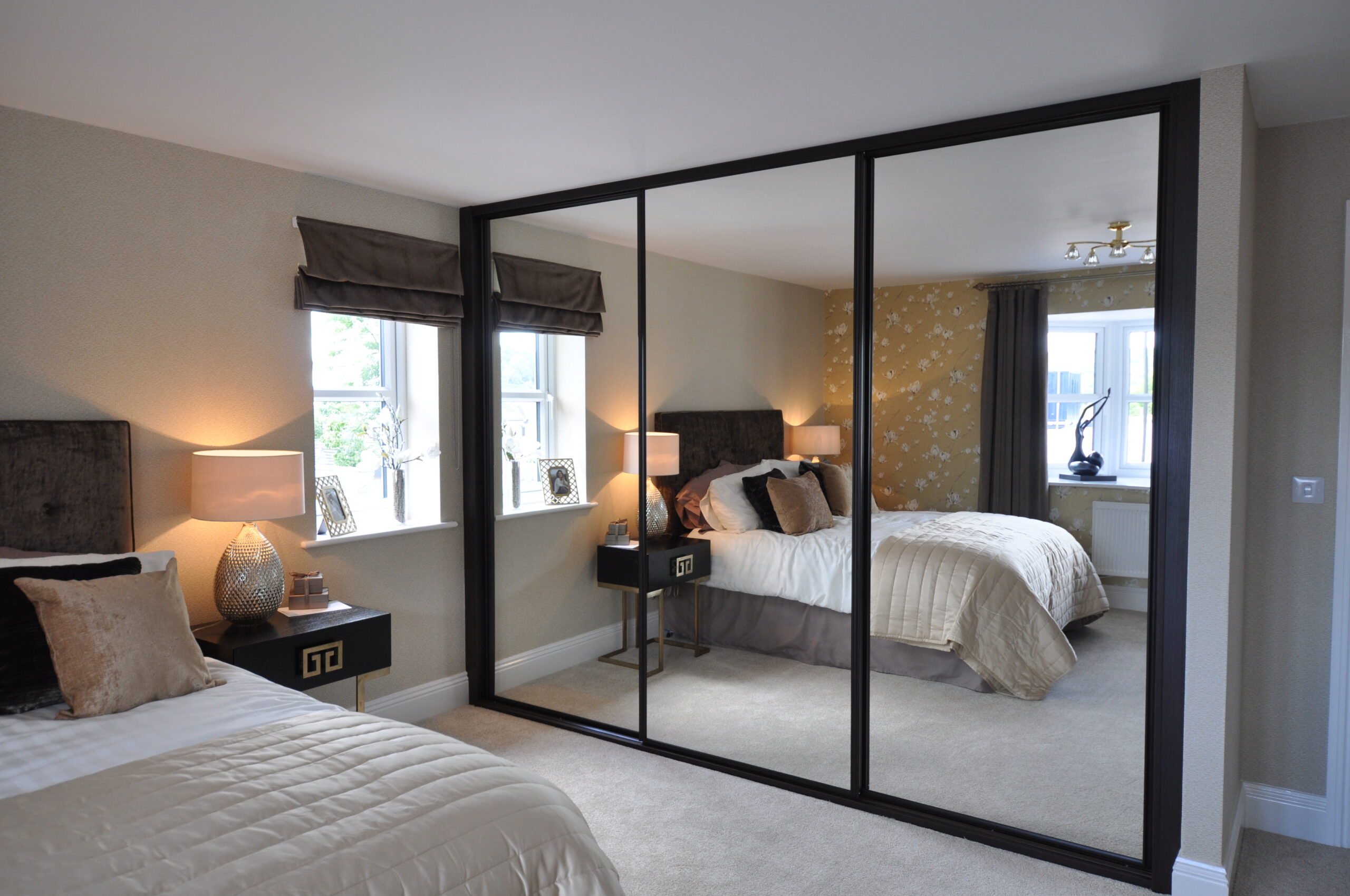 Mirrored sliding wardrobe in a styled bedroom