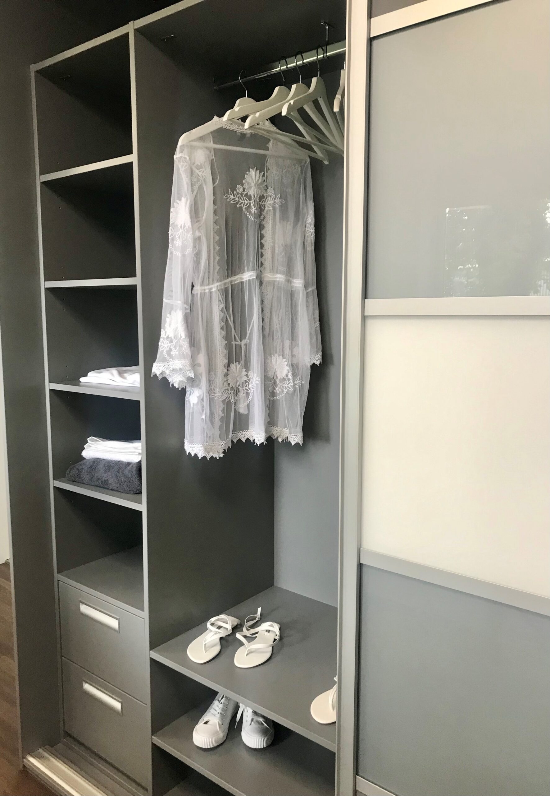 Fitted wardrobe interior with shelving, hanging and drawer stack