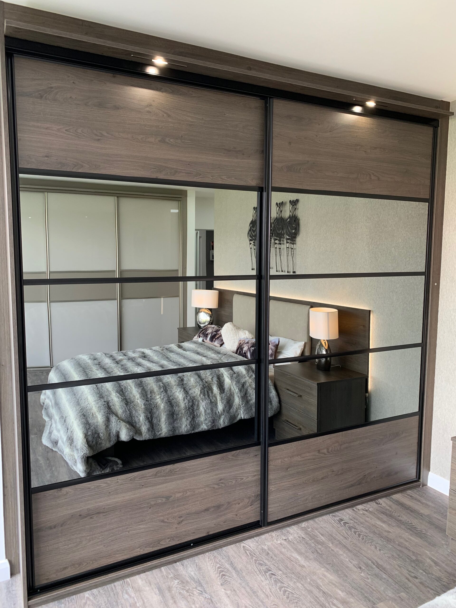 Black-framed five-split wardrobe in Denver Oak with grey mirror