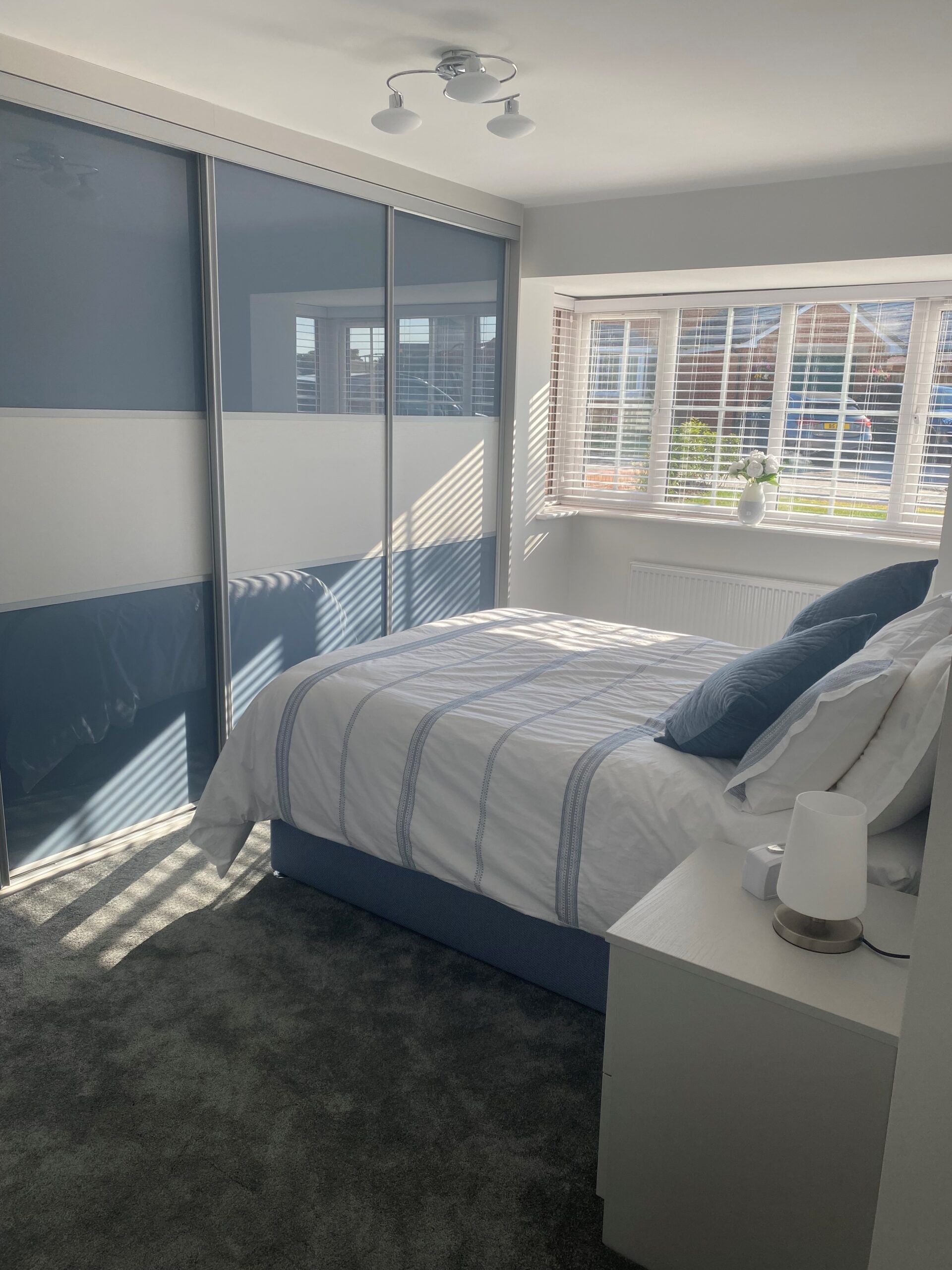 Traditional Plus sliding wardrobe in Blue Shadow glass and light grey wood